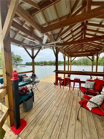 a view of a porch with furniture and wooden floor