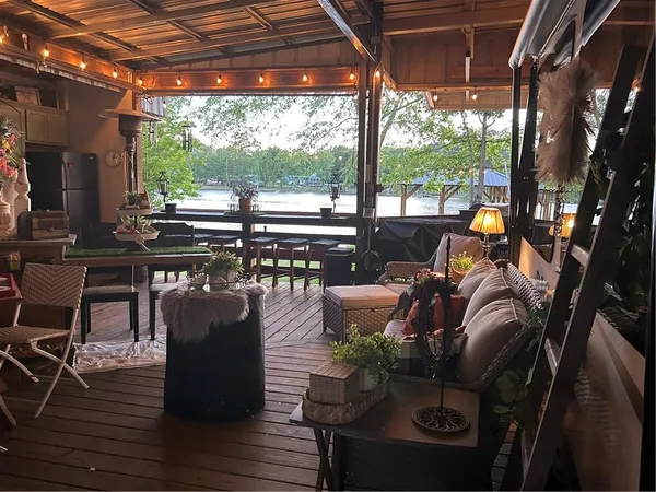 a view of a patio with dining table and chairs with a barbeque grill