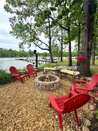 a view of a outdoor space with seating area and trees around