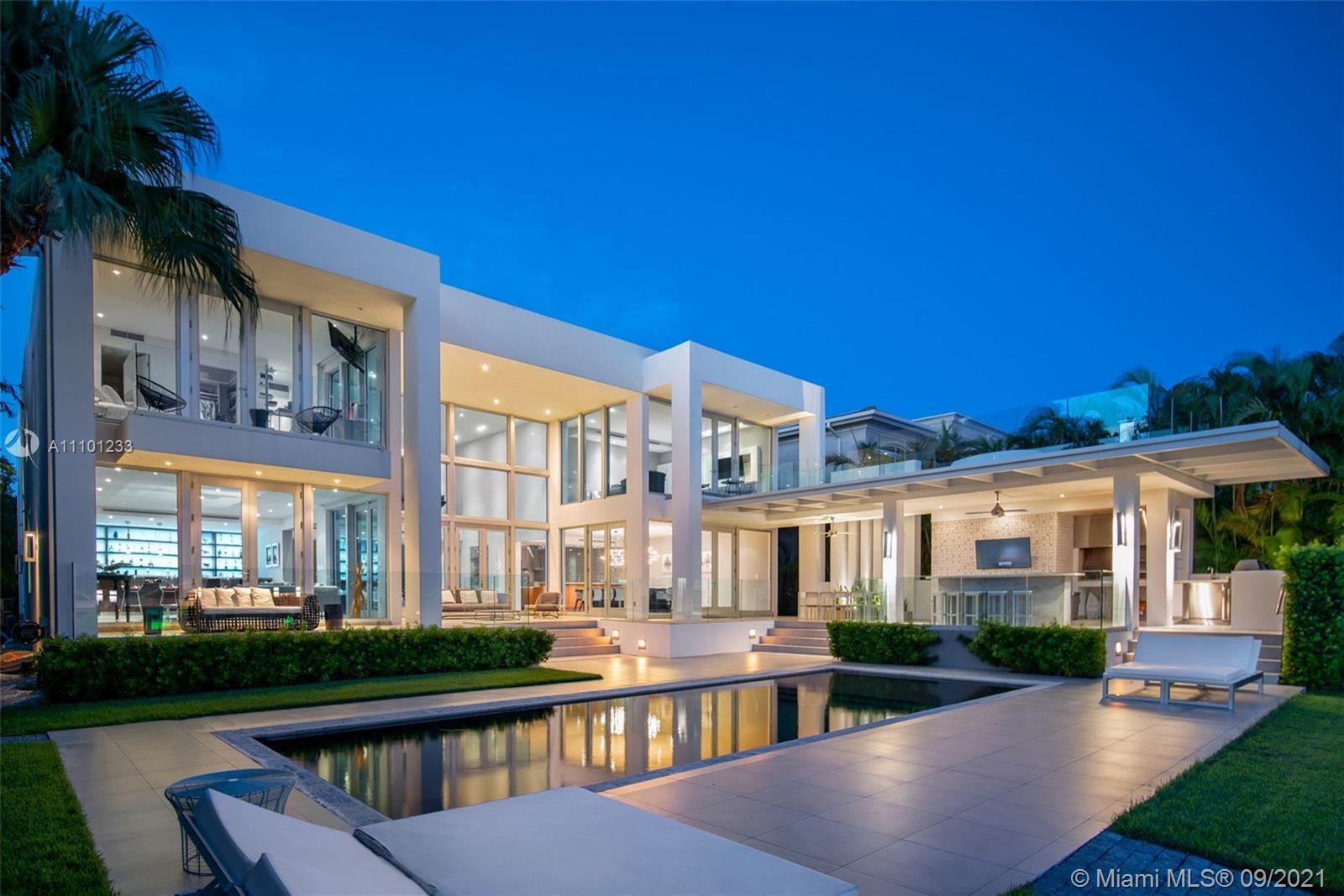 1236 Biscaya Drive Surfside, FL 33154 - Photo 2 of 40 a view of a house with pool and chairs