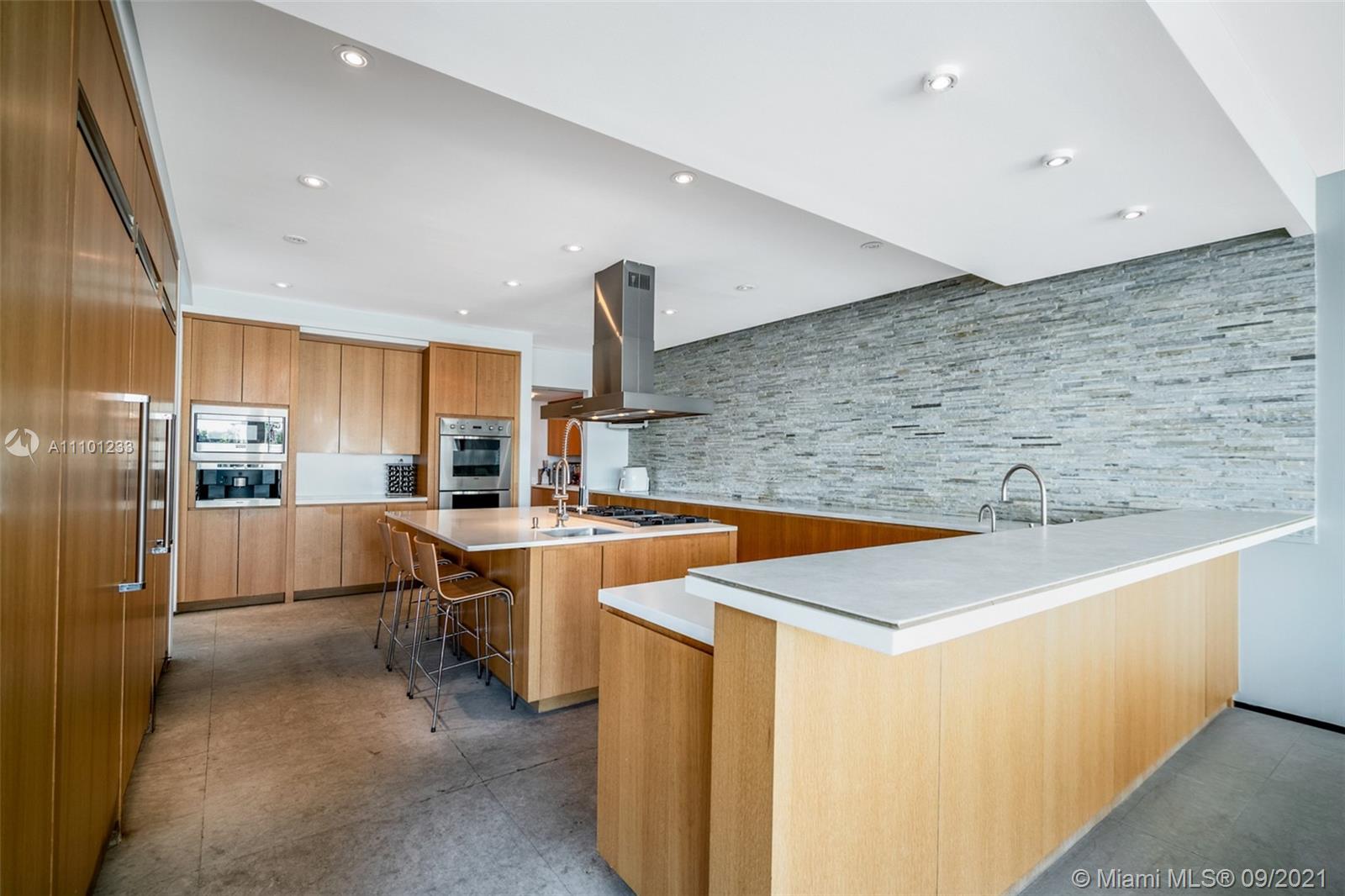 1236 Biscaya Drive Surfside, FL 33154 - Photo 13 of 40 a kitchen with stainless steel appliances a sink a stove a refrigerator and cabinets