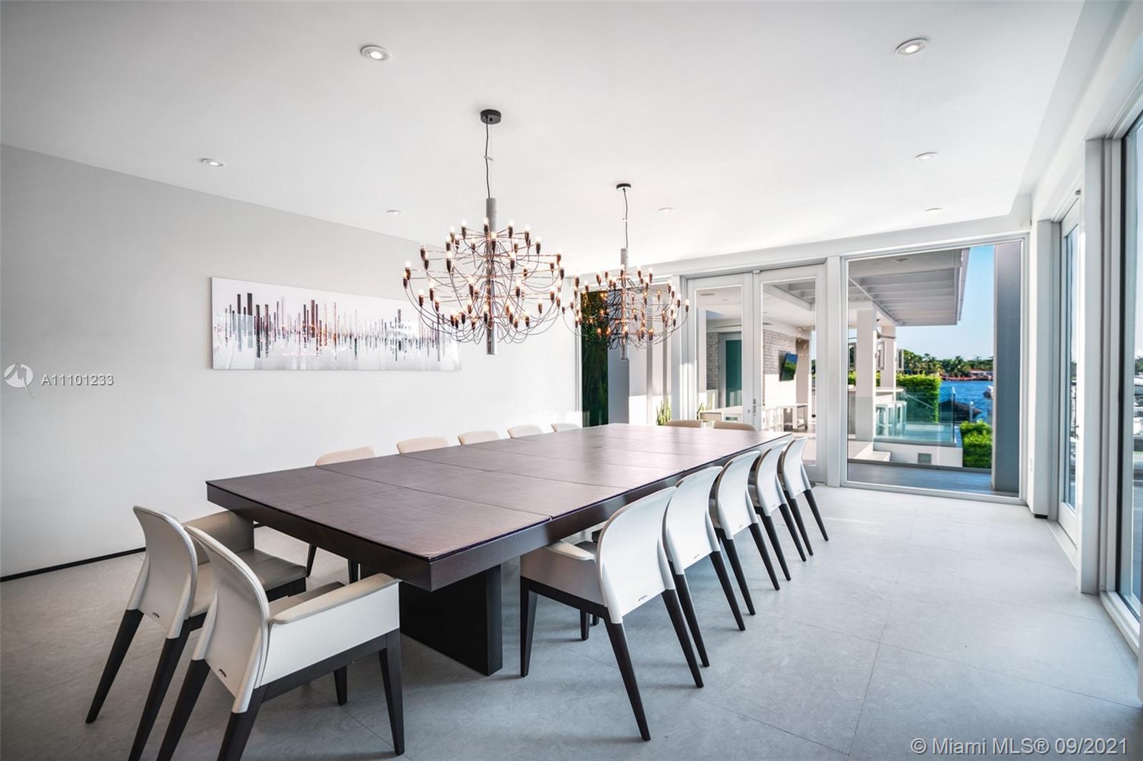 1236 Biscaya Drive Surfside, FL 33154 - Photo 14 of 40 a view of a dining room and livingroom with furniture wooden floor a chandelier