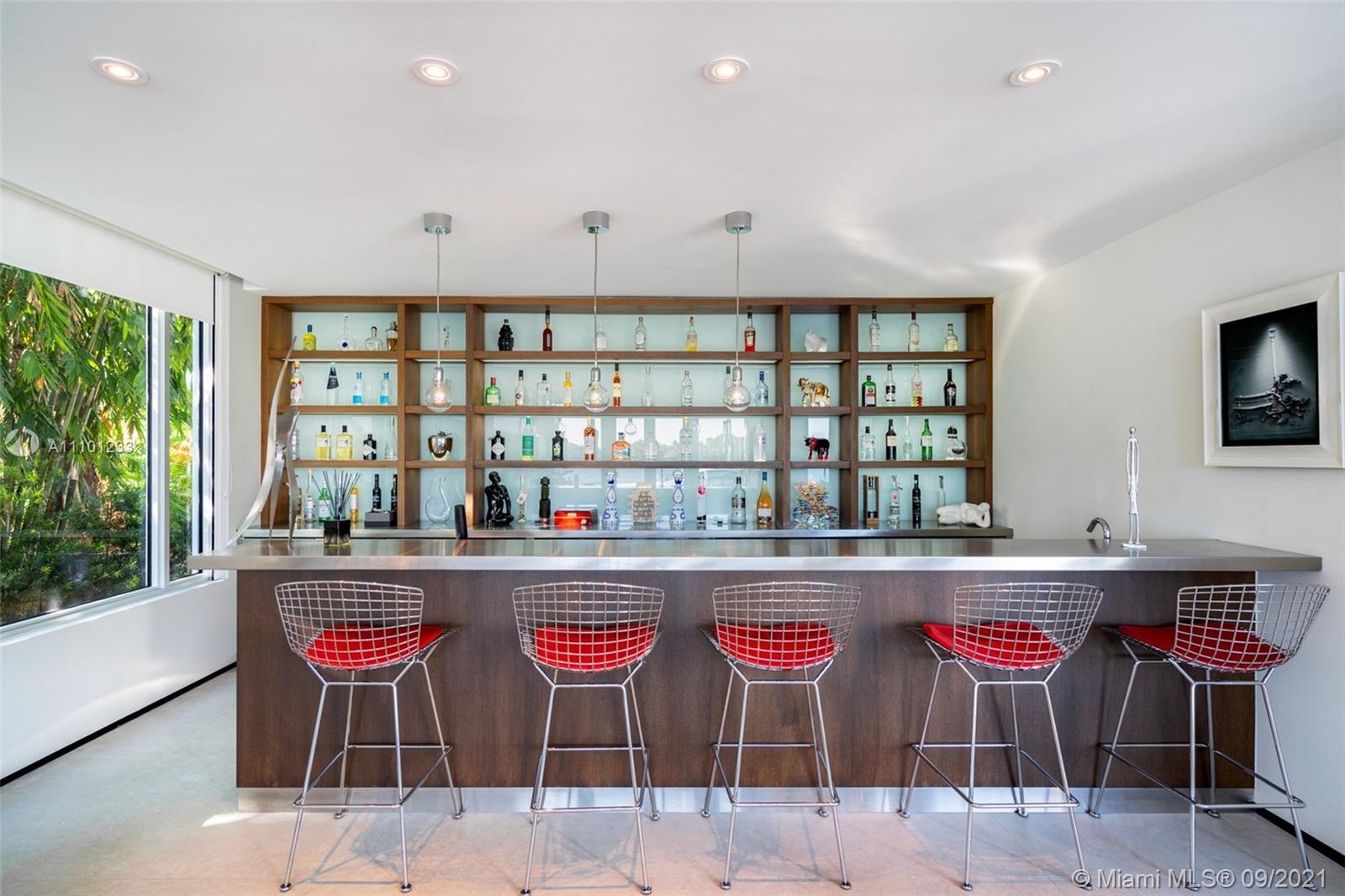 1236 Biscaya Drive Surfside, FL 33154 - Photo 15 of 40 a kitchen with stainless steel appliances kitchen island granite countertop a dining table and chairs