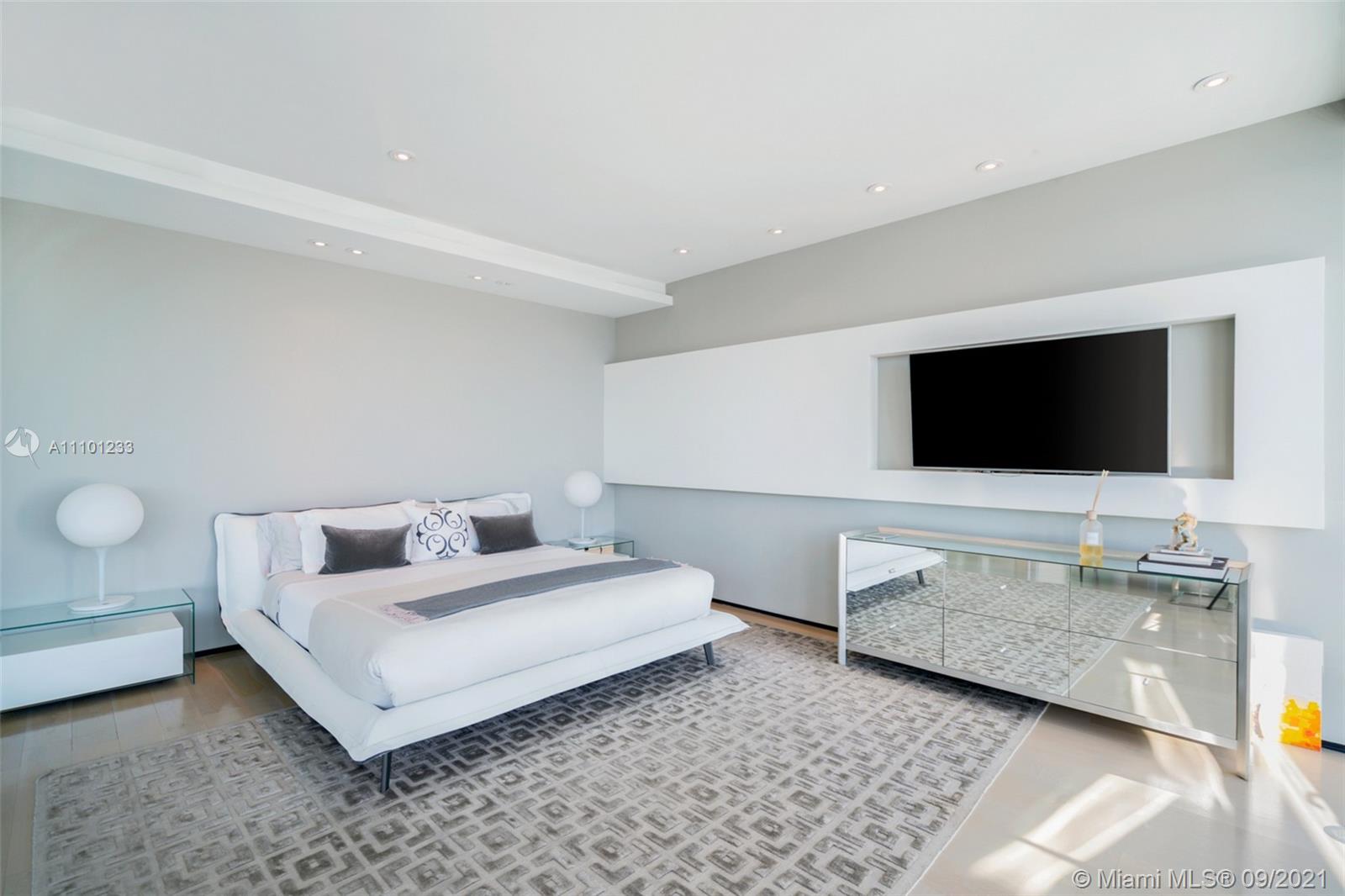 1236 Biscaya Drive Surfside, FL 33154 - Photo 20 of 40 a living room with furniture and a flat screen tv