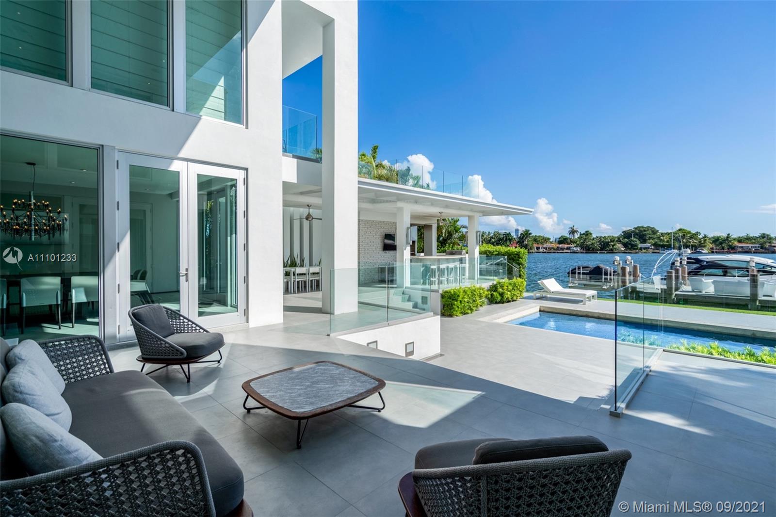 1236 Biscaya Drive Surfside, FL 33154 - Photo 25 of 40 a building outdoor space with patio furniture and glass door