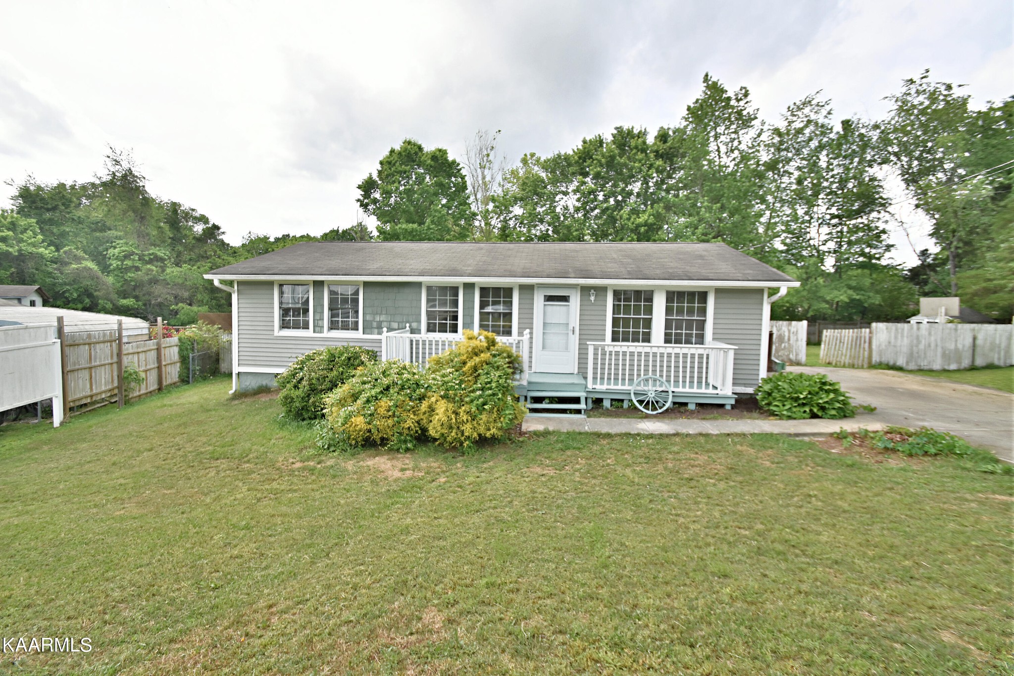 a view of a house with a yard and sitting area