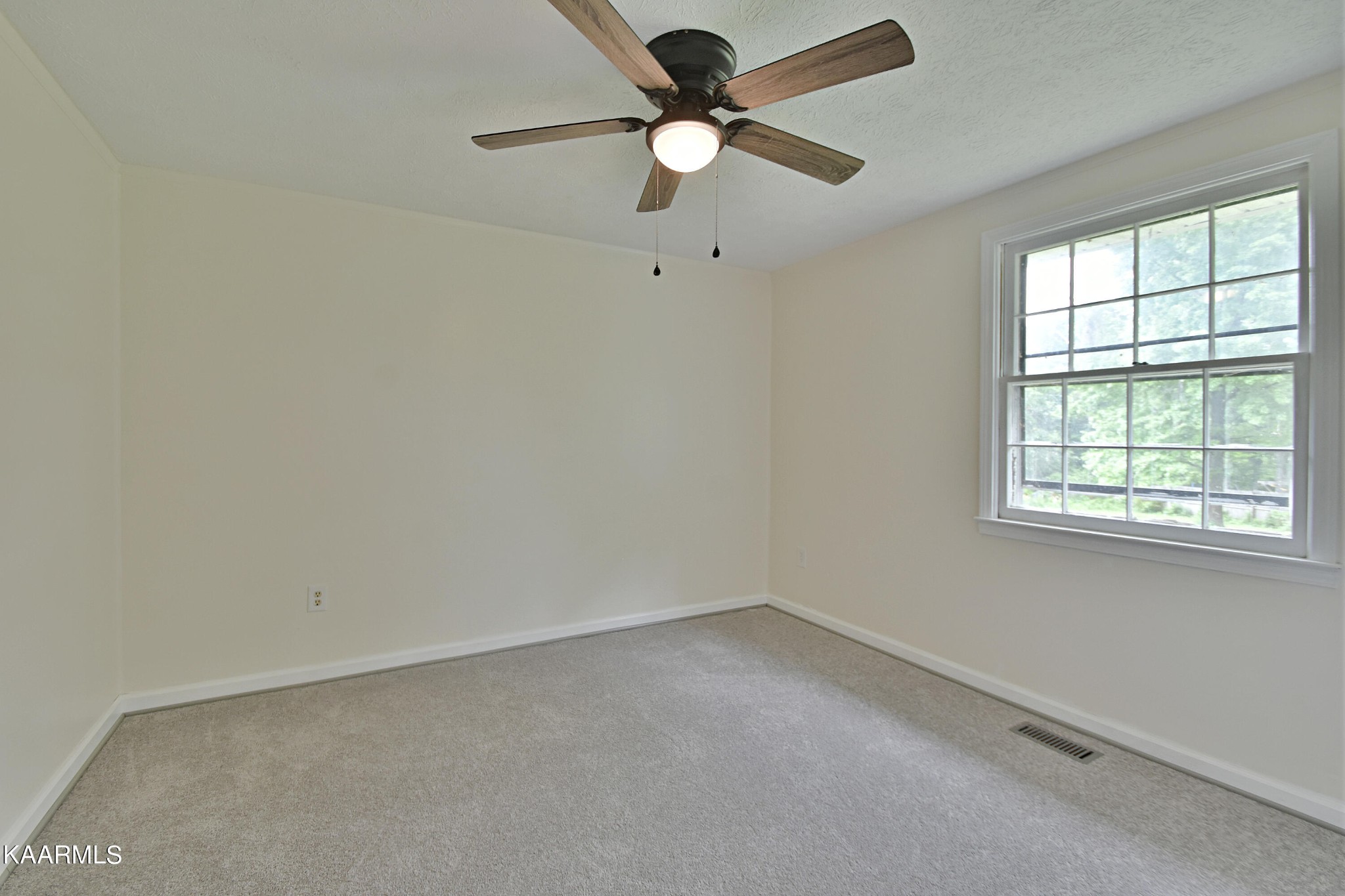 7715 Nicholas Drive Corryton, TN 37721 - Photo 12 of 16 an empty room with a window and a fan