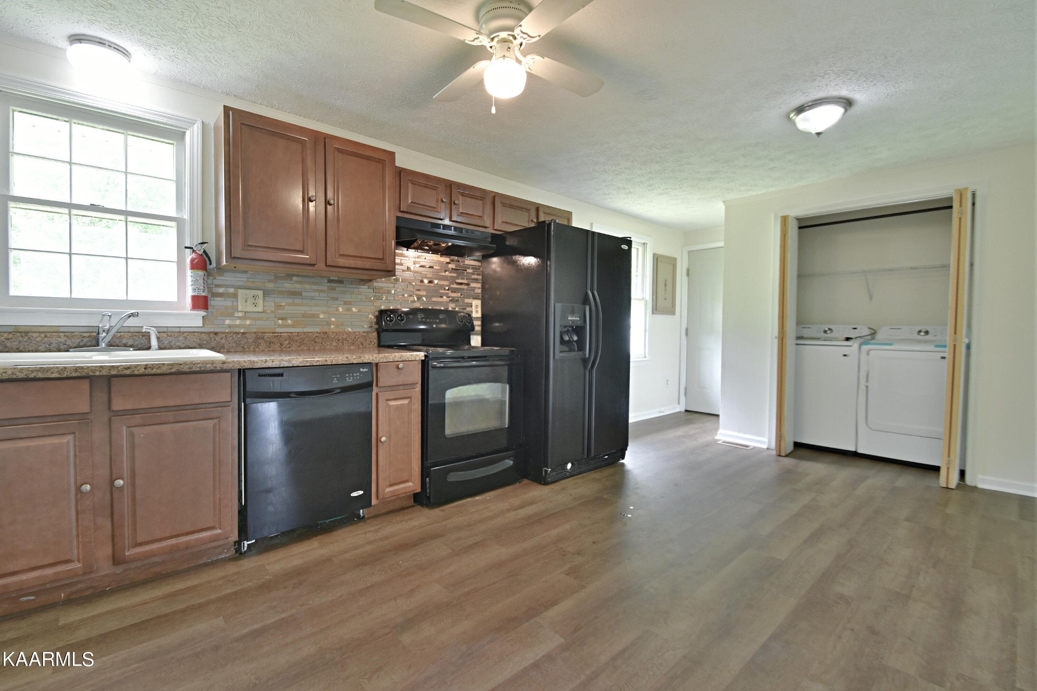 7715 Nicholas Drive Corryton, TN 37721 - Photo 5 of 16 a kitchen with a sink cabinets stainless steel appliances and a window