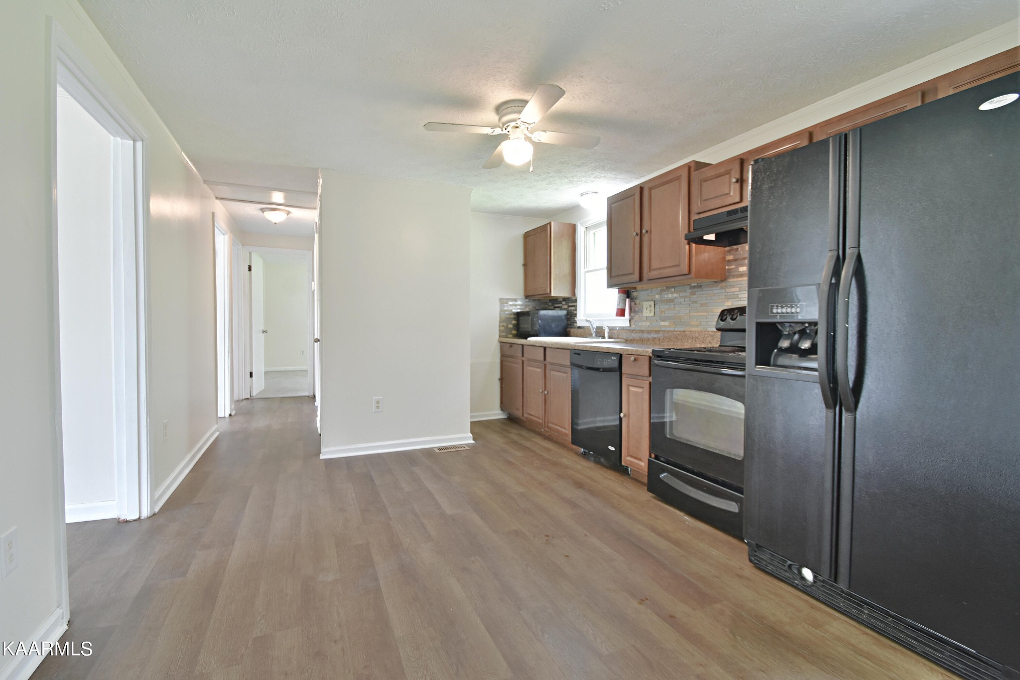7715 Nicholas Drive Corryton, TN 37721 - Photo 6 of 16 a kitchen with stainless steel appliances a stove a refrigerator sink and cabinets