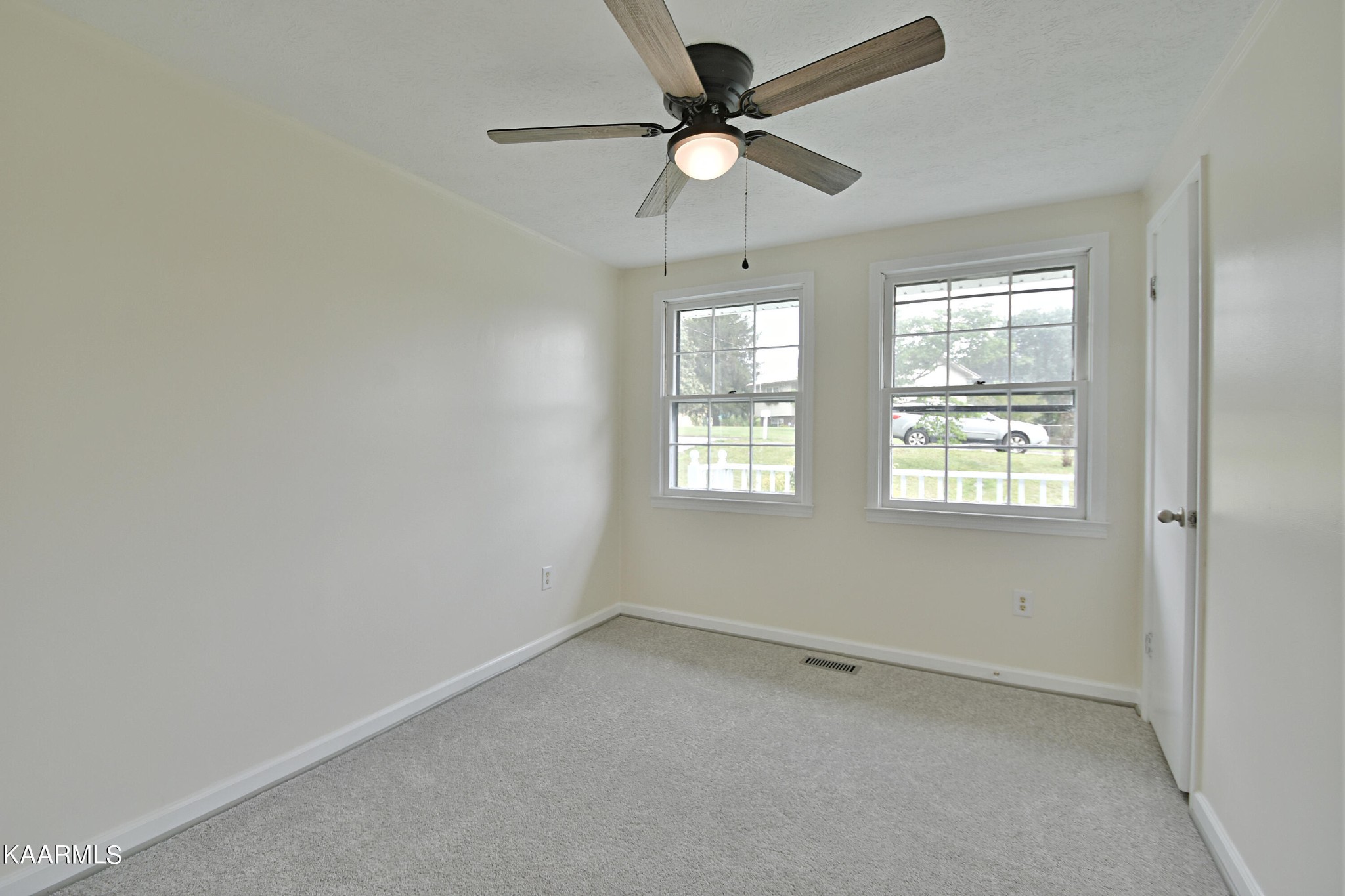 7715 Nicholas Drive Corryton, TN 37721 - Photo 7 of 16 an empty room with a window and a fan