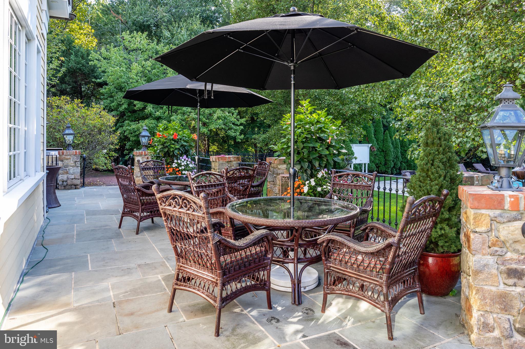 343 Bridgeboro Road Moorestown, NJ 08057 - Photo 44 of 52 a view of a chairs and table under an umbrella in the patio