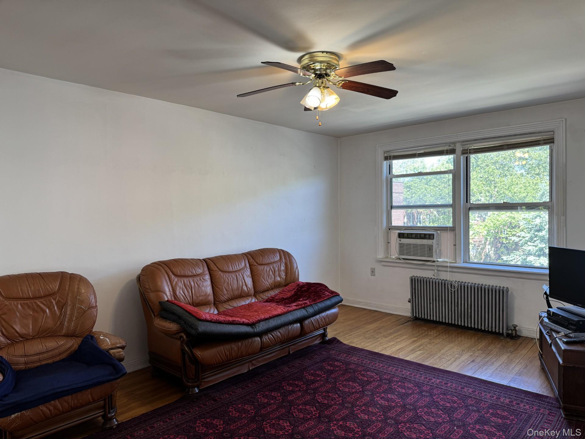141-24 78th Road, Unit 3A Queens, NY 11367 - Photo 4 of 18 a living room with furniture and a window