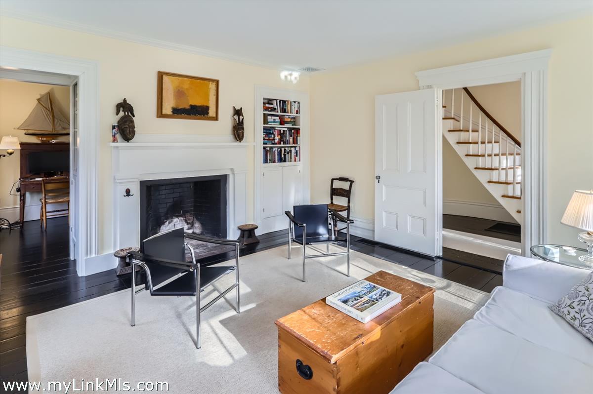 27 Spring Street Vineyard Haven, MA 02568 - Photo 25 of 58 a living room with furniture a rug and a fireplace