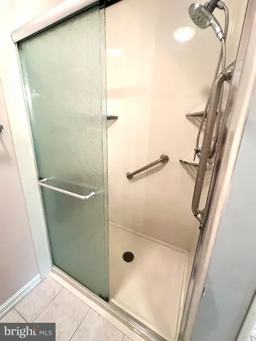 a bathroom with a glass shower door