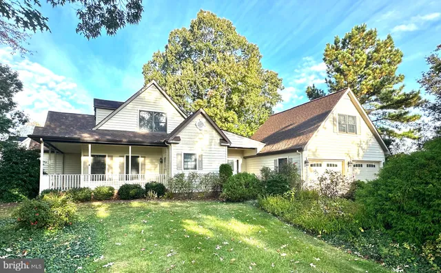 a view of a house with a yard and potted plants