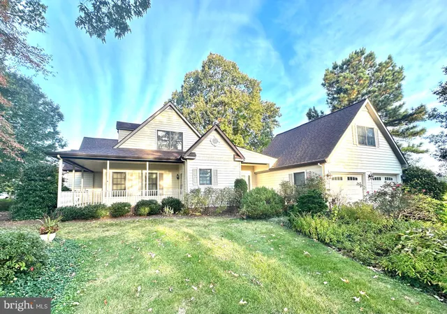 a view of a house with a yard and potted plants