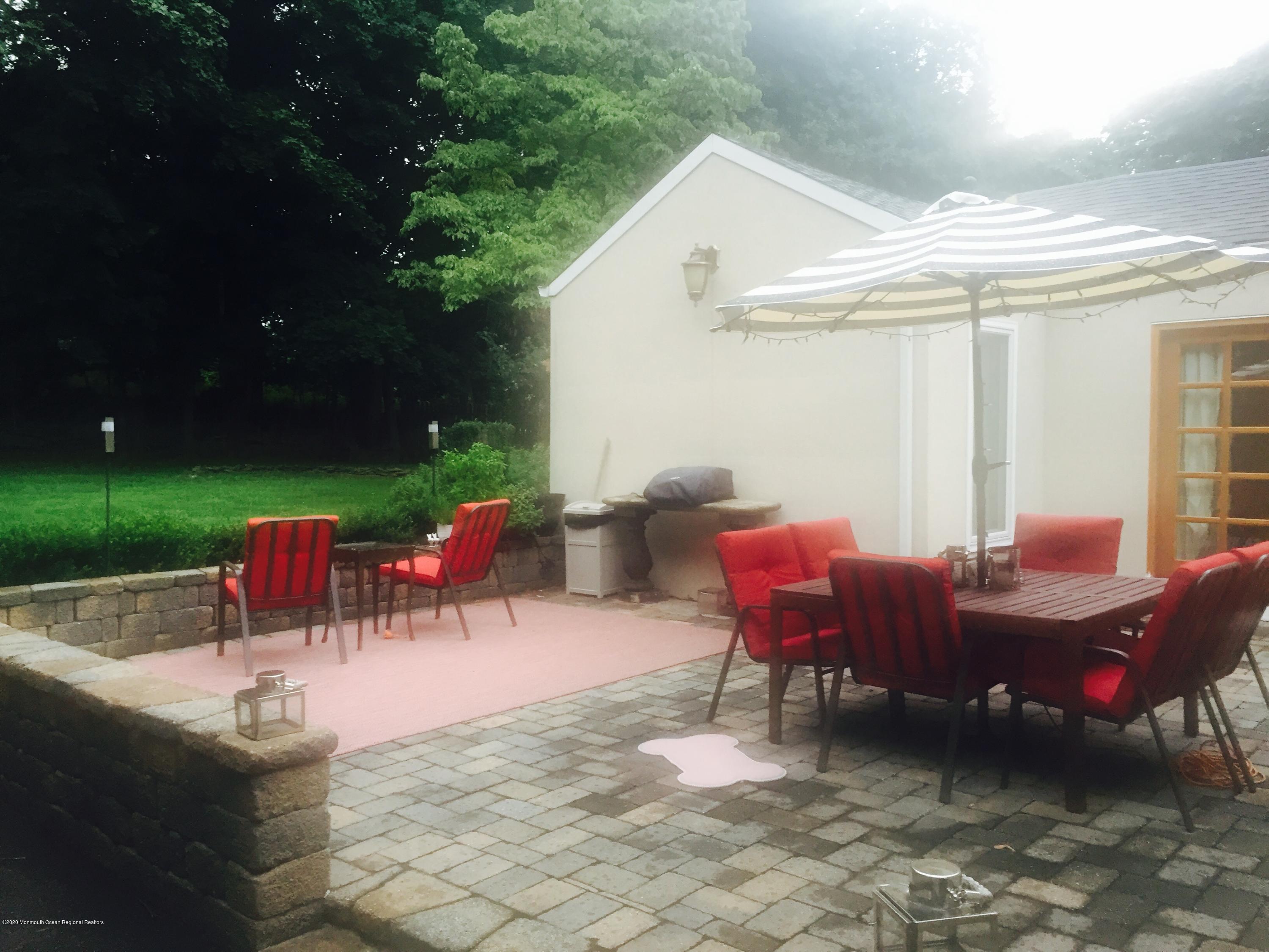 431 Spring Street Little Silver, NJ 07739 - Photo 11 of 15 a view of a patio with a table and chairs