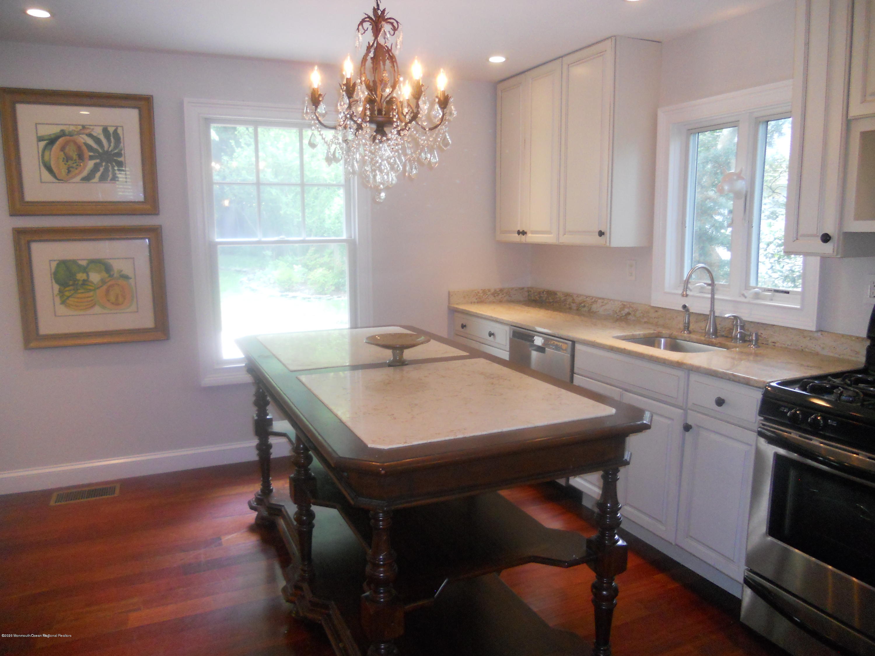 431 Spring Street Little Silver, NJ 07739 - Photo 3 of 15 a kitchen with a table chairs sink and cabinets
