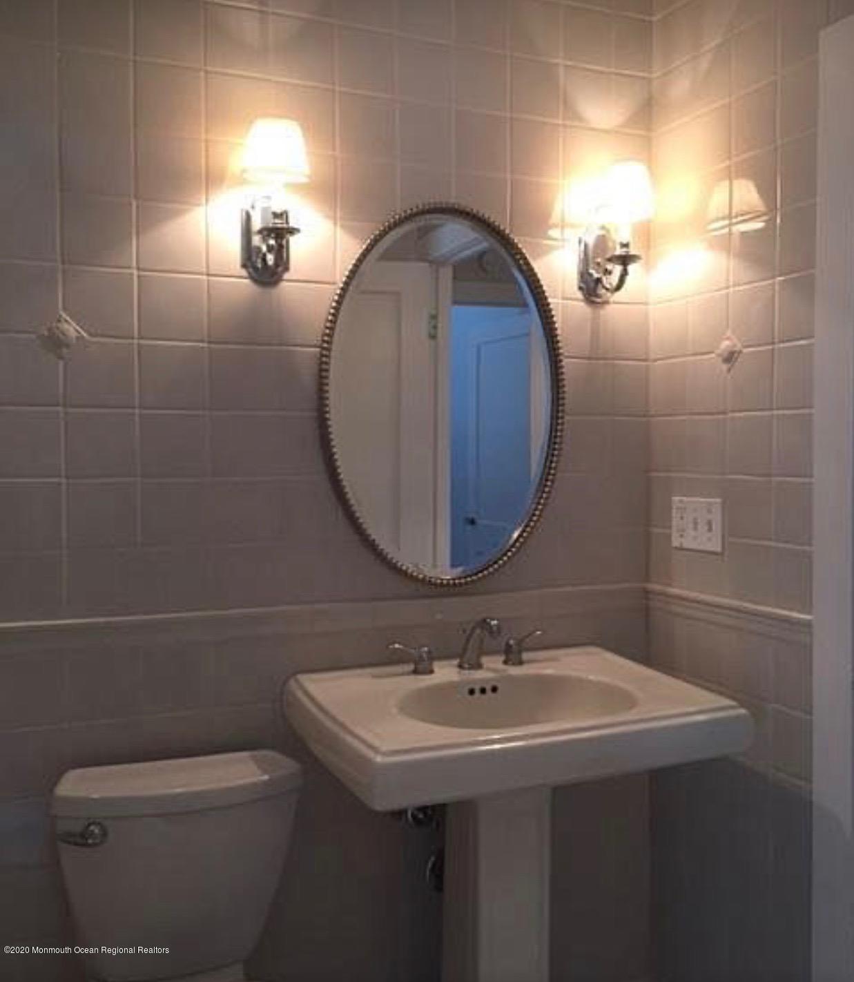 431 Spring Street Little Silver, NJ 07739 - Photo 4 of 15 a bathroom with a sink a toilet and a mirror