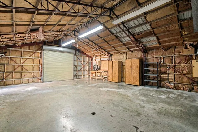 a view of empty room with refrigerator