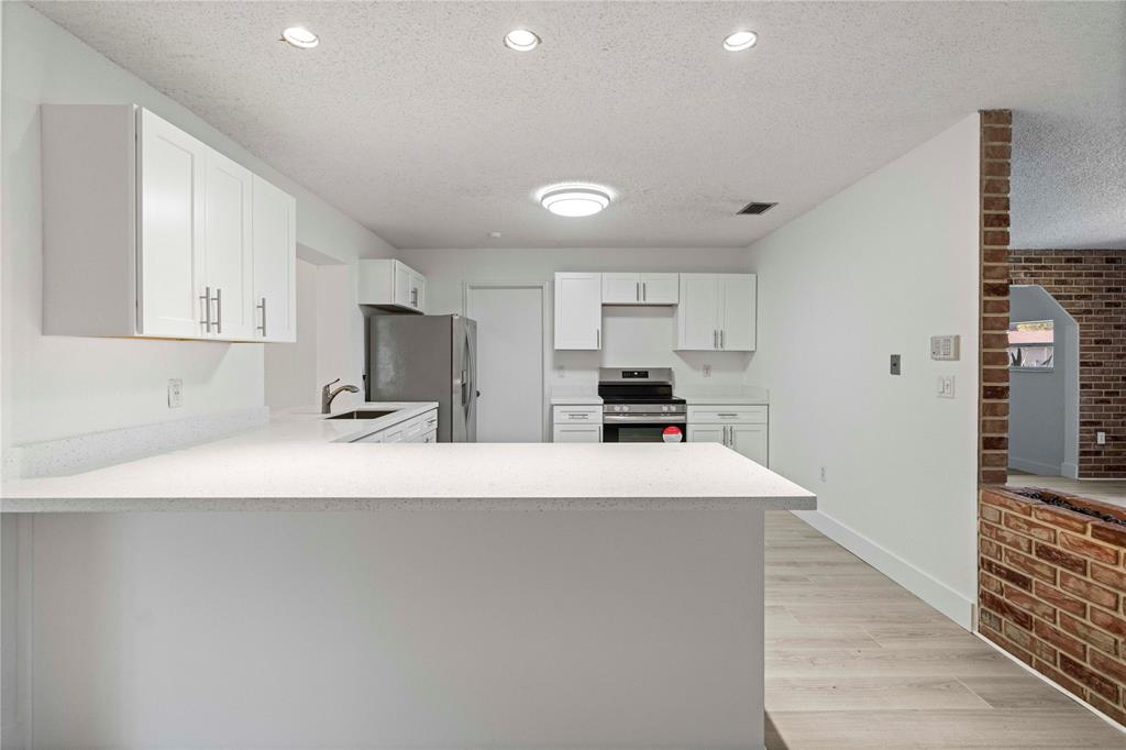 16900 Southwest 62nd Street Southwest Ranches, FL 33331 - Photo 17 of 48 a kitchen with stainless steel appliances a refrigerator sink and cabinets