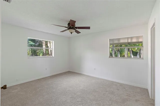 a bathroom with a granite countertop sink a mirror a toilet and a bathtub
