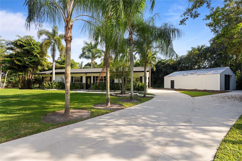 16900 Southwest 62nd Street Southwest Ranches, FL 33331 - Photo 4 of 48 a view of a house with a yard and palm trees