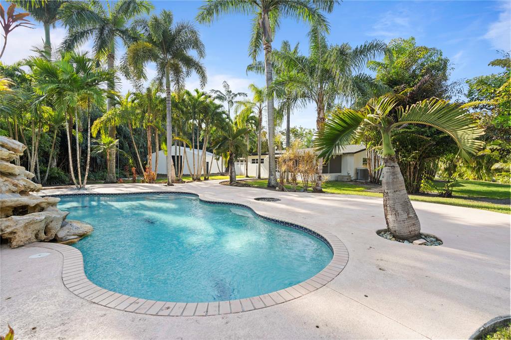 16900 Southwest 62nd Street Southwest Ranches, FL 33331 - Photo 7 of 48 a view of a swimming pool with a house