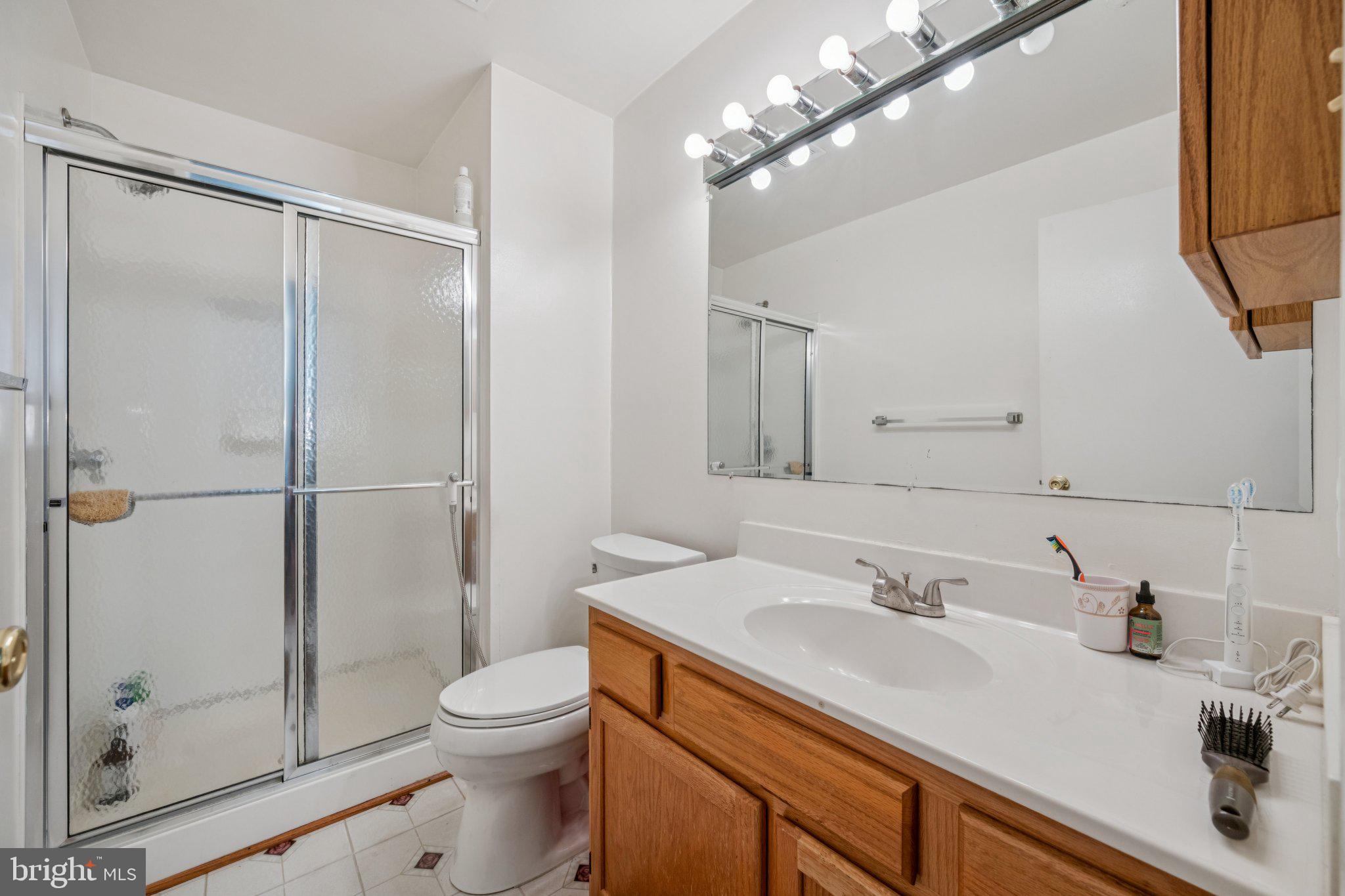 10522 East Wind Way Columbia, MD 21044 - Photo 11 of 21 a bathroom with a sink a toilet and shower