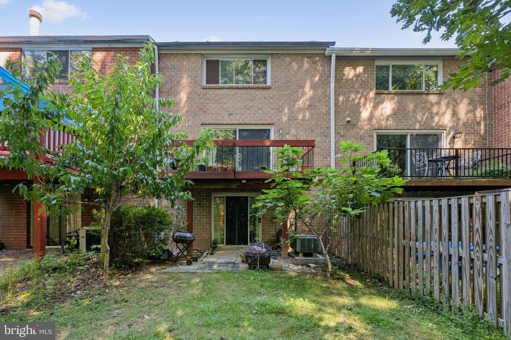 10522 East Wind Way Columbia, MD 21044 - Photo 20 of 21 a view of a brick house with a yard and plants