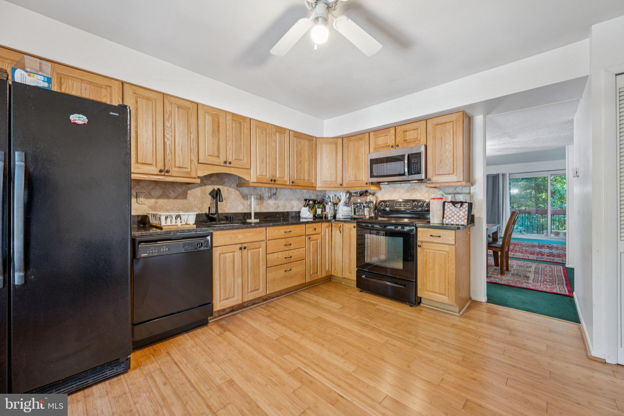 10522 East Wind Way Columbia, MD 21044 - Photo 2 of 21 a kitchen with granite countertop a refrigerator stove top oven and sink