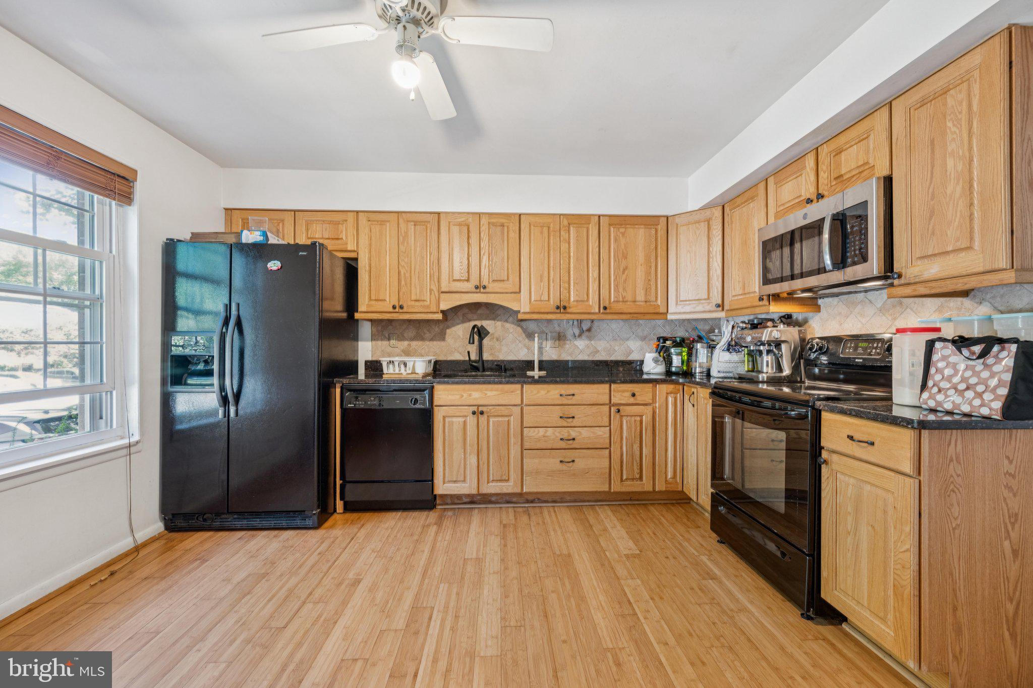 10522 East Wind Way Columbia, MD 21044 - Photo 3 of 21 a kitchen with granite countertop a refrigerator stove top oven and sink