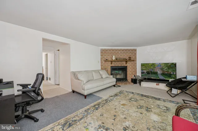 a living room with furniture flat screen tv and a fireplace