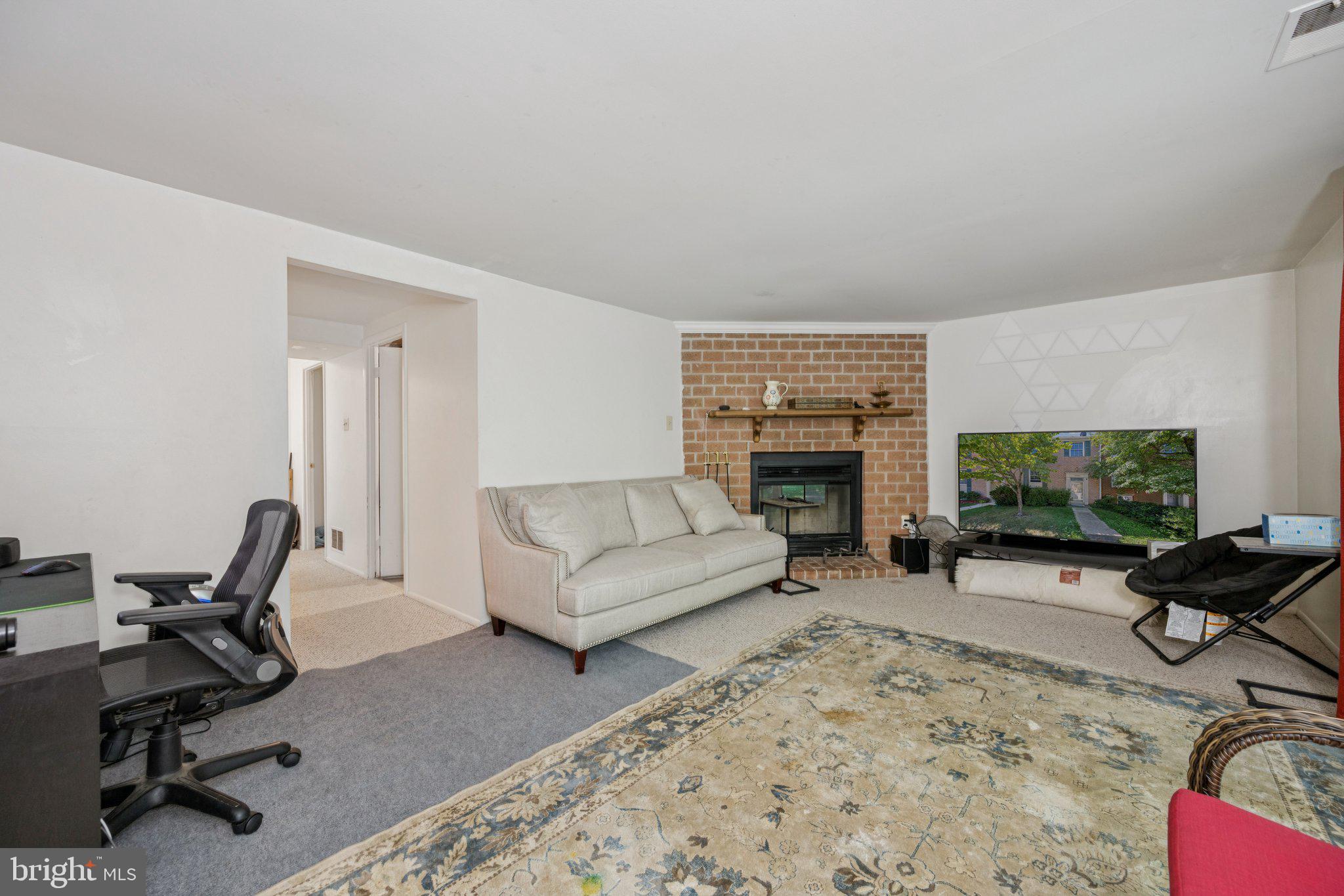 10522 East Wind Way Columbia, MD 21044 - Photo 4 of 21 a living room with furniture flat screen tv and a fireplace