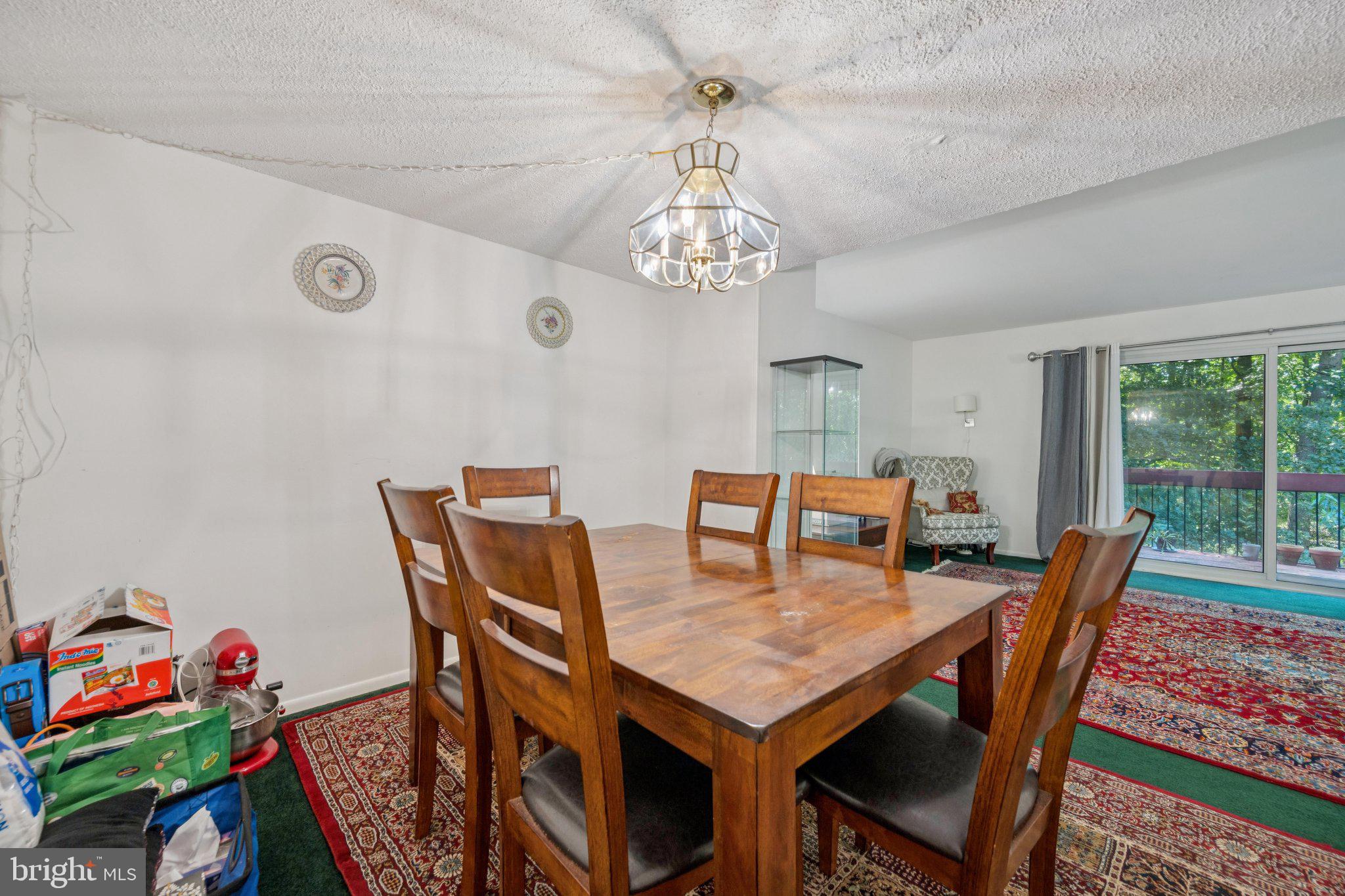 10522 East Wind Way Columbia, MD 21044 - Photo 6 of 21 a view of a dining room with furniture a chandelier and a window