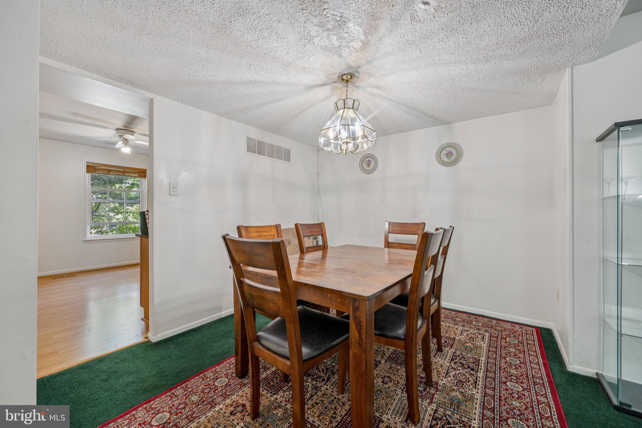 10522 East Wind Way Columbia, MD 21044 - Photo 7 of 21 a view of a dining room with furniture and chandelier