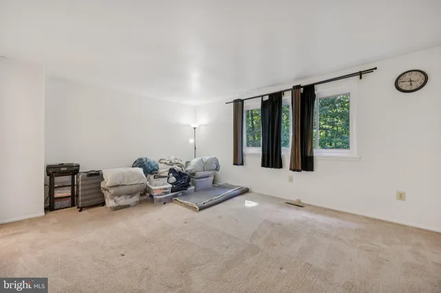 a living room with furniture and large windows