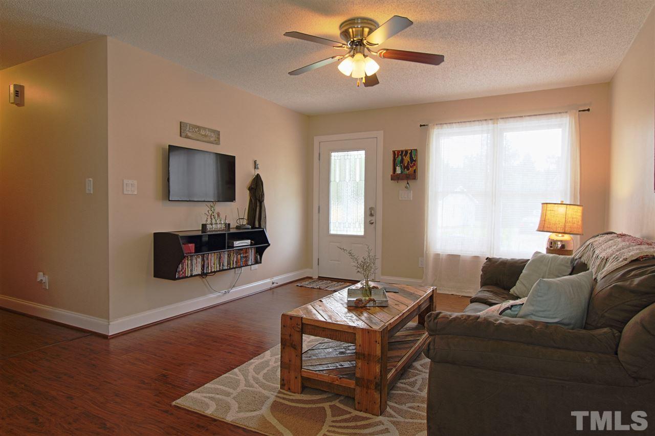 4213 Bluewing Road Raleigh, NC 27616 - Photo 2 of 16 a living room with furniture and a flat screen tv