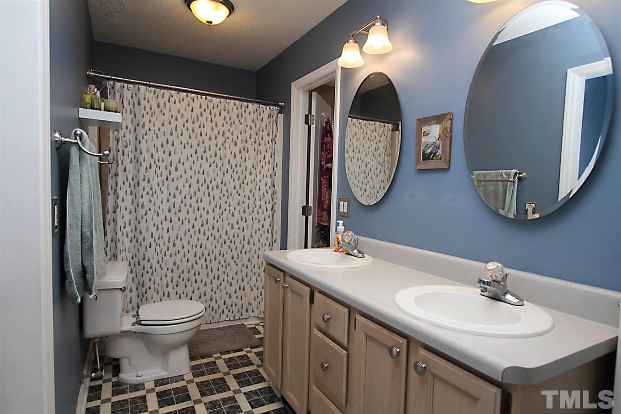 4213 Bluewing Road Raleigh, NC 27616 - Photo 11 of 16 a bathroom with a sink and a mirror