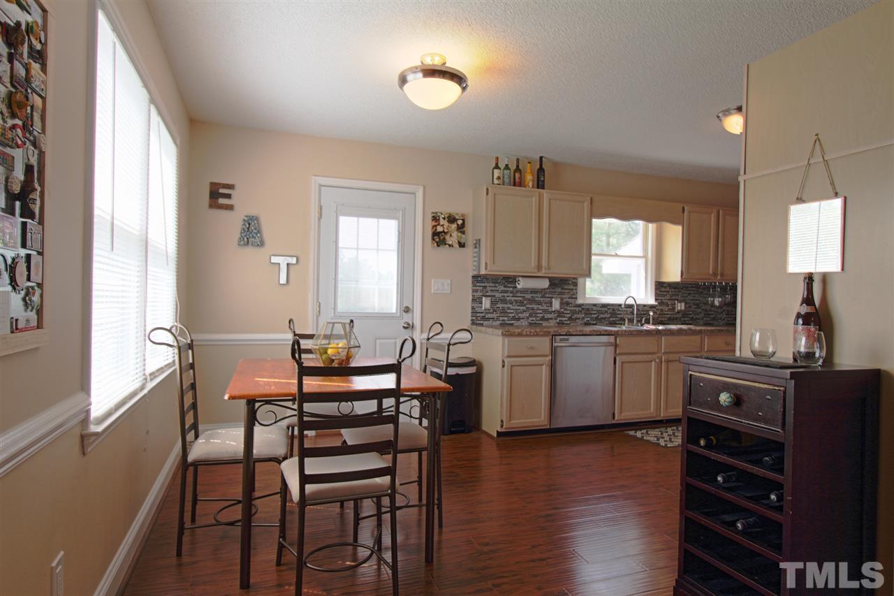 4213 Bluewing Road Raleigh, NC 27616 - Photo 5 of 16 a kitchen with granite countertop cabinets and chair