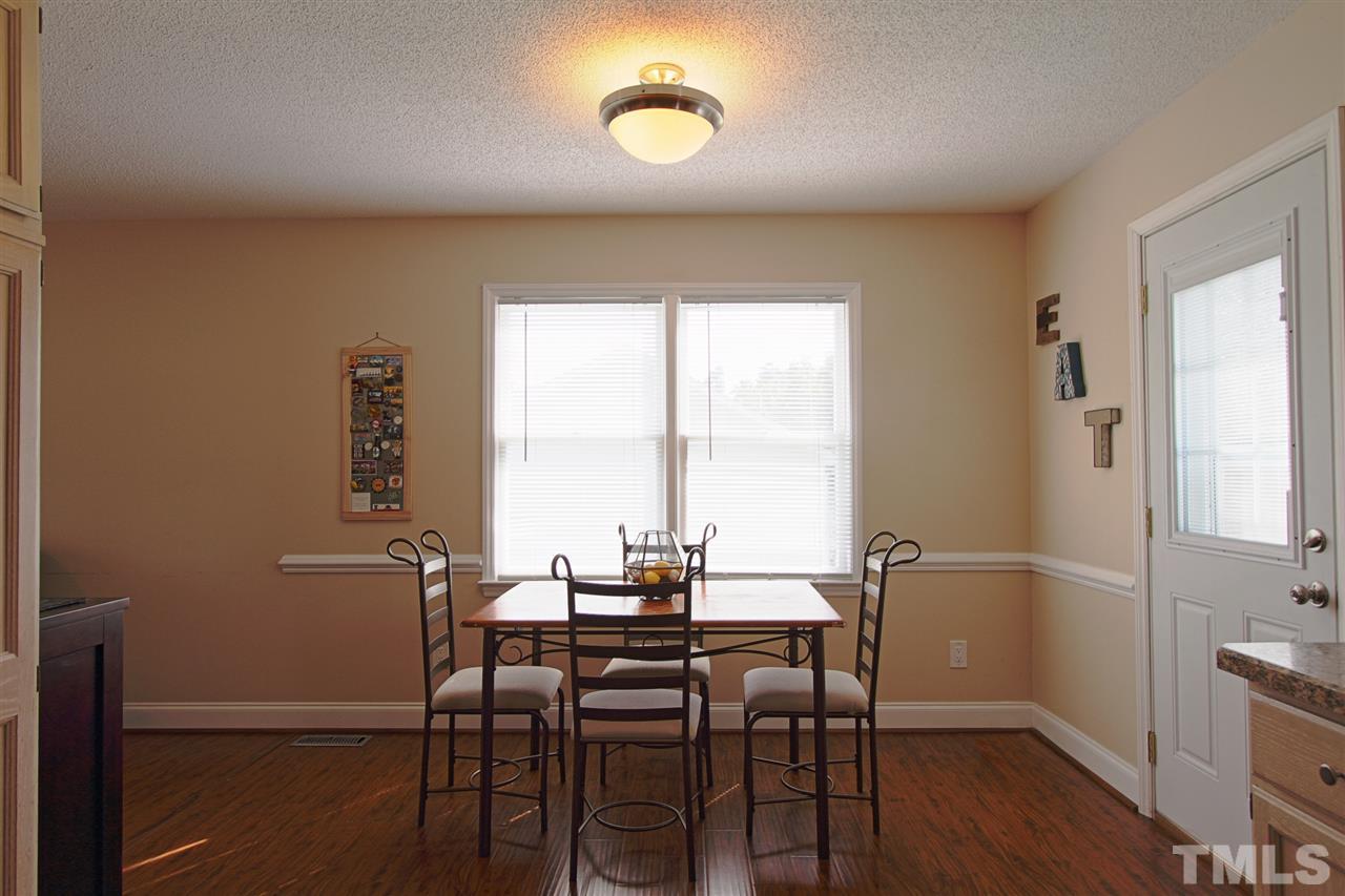 4213 Bluewing Road Raleigh, NC 27616 - Photo 6 of 16 a view of a dining room with furniture window and wooden floor