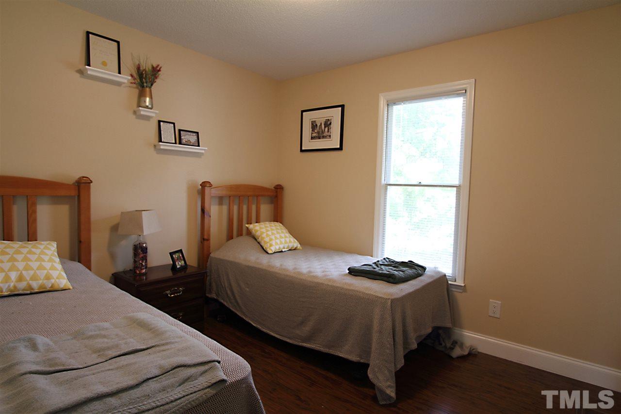 4213 Bluewing Road Raleigh, NC 27616 - Photo 10 of 16 a bedroom with two beds and a window
