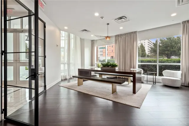 a living room with furniture wooden floor and a large window