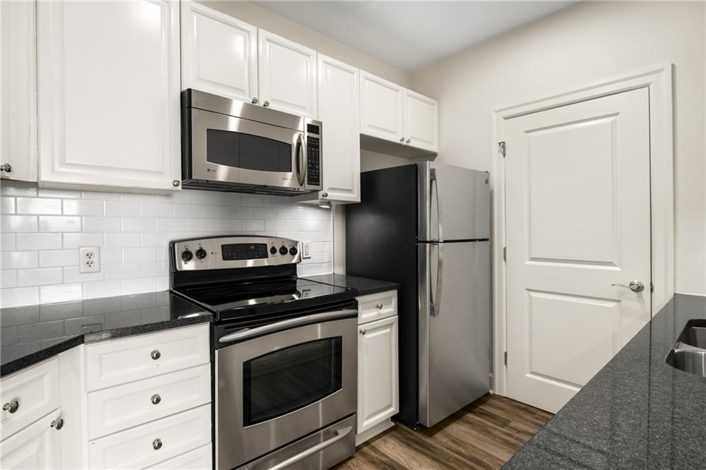325 East Paces Ferry Road Northeast, Unit 1704 Atlanta, GA 30305 - Photo 18 of 43 a kitchen with stainless steel appliances a stove a microwave and a refrigerator