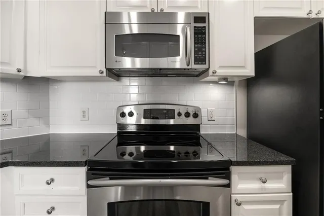 a stove top oven sitting inside of a kitchen