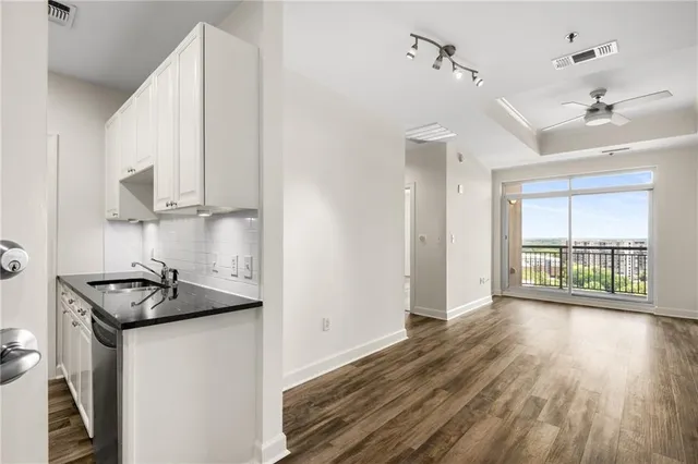 a kitchen that has a sink and a stove in it