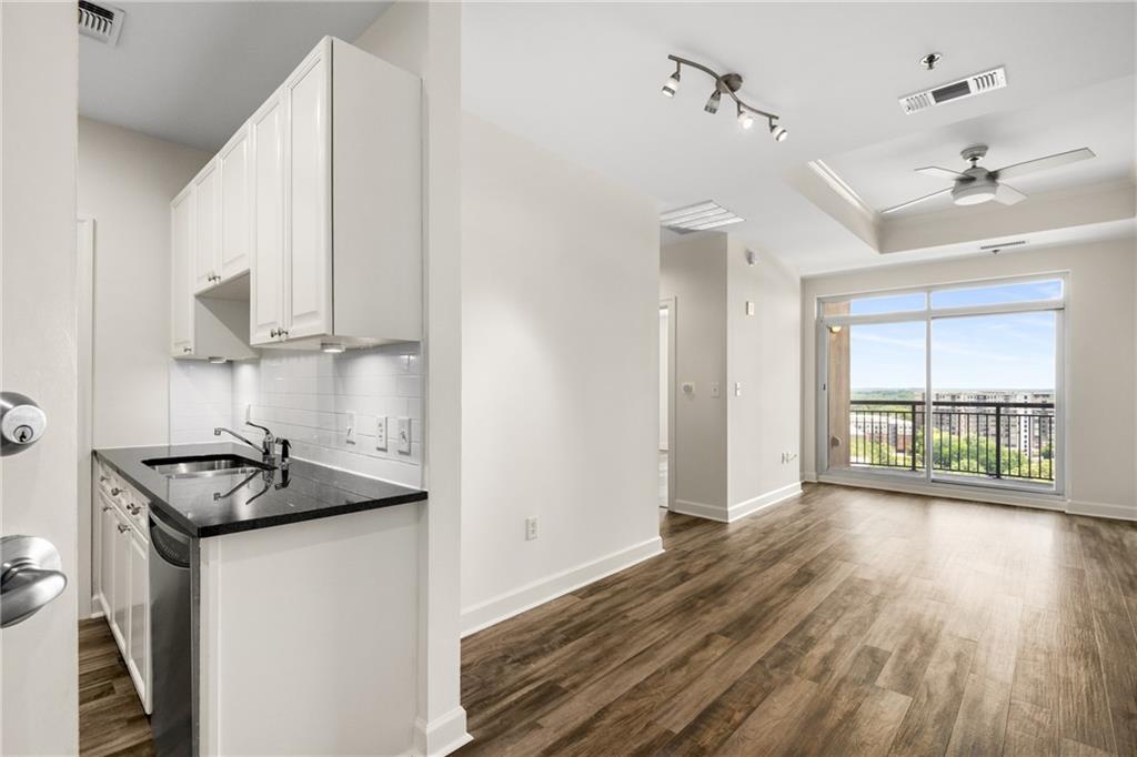 325 East Paces Ferry Road Northeast, Unit 1704 Atlanta, GA 30305 - Photo 20 of 43 a kitchen that has a sink and a stove in it