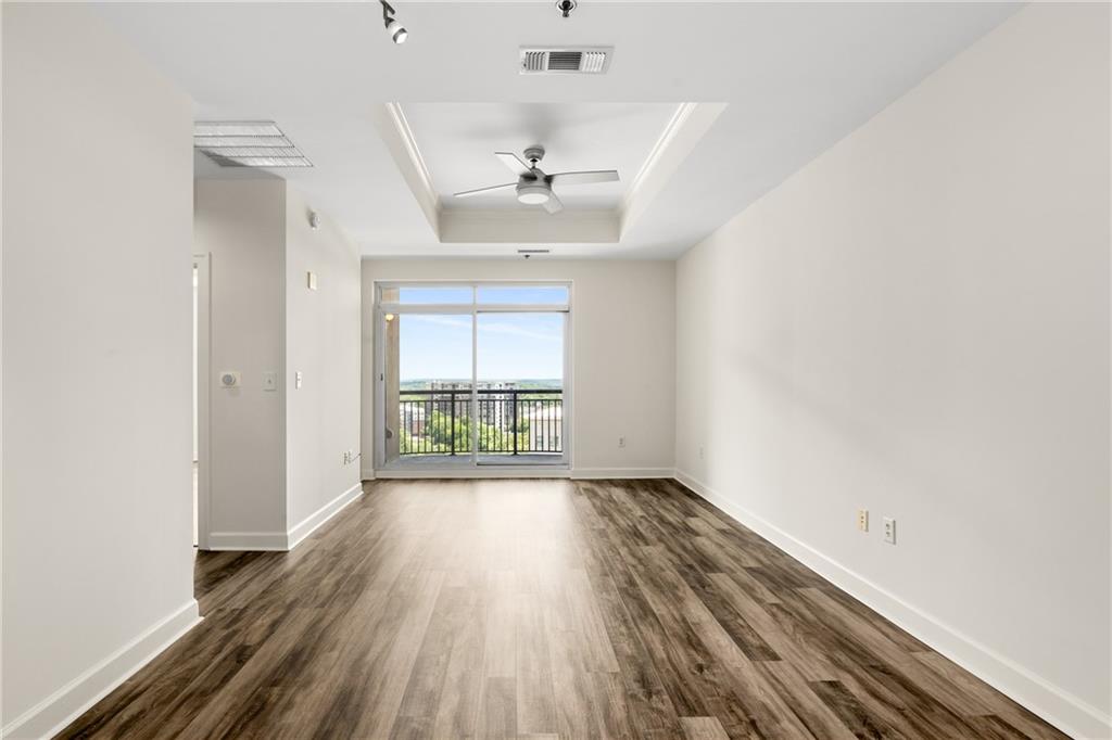 325 East Paces Ferry Road Northeast, Unit 1704 Atlanta, GA 30305 - Photo 21 of 43 wooden floor in an empty room with a window