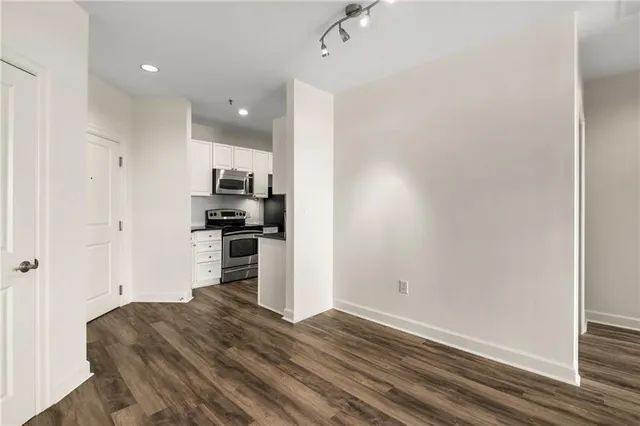 a kitchen with a refrigerator and a stove top oven