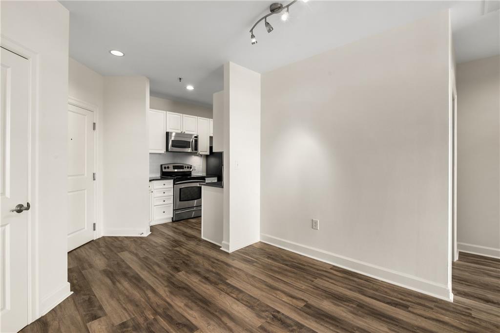 325 East Paces Ferry Road Northeast, Unit 1704 Atlanta, GA 30305 - Photo 23 of 43 a kitchen with a refrigerator and a stove top oven